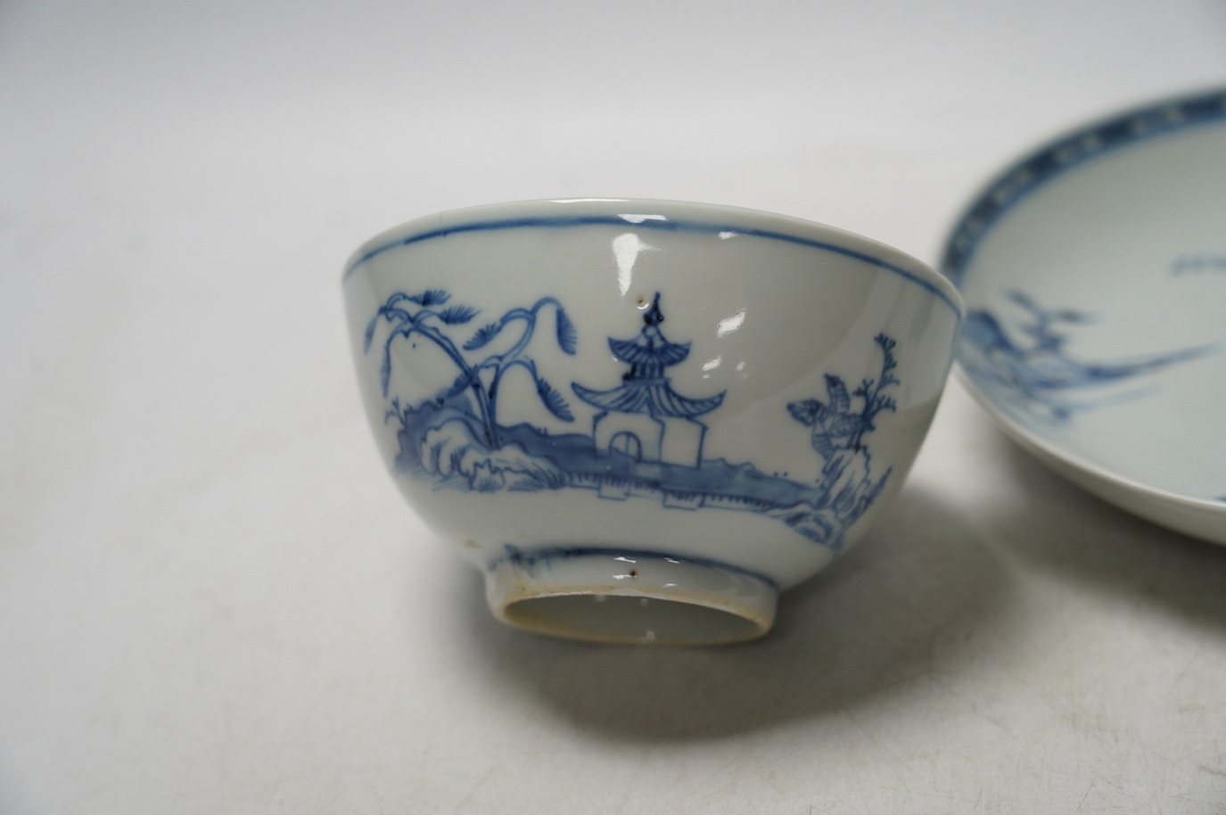 A large Chinese Nanking cargo blue and white tea bowl and saucer, saucer 17.5cm. Condition - good